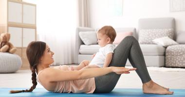 Mujer haciendo ejercicio junto a su bebé